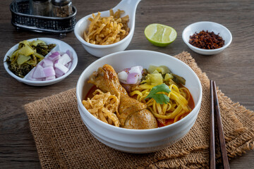Khao Soi Kai, Thai Noodles Khao Soi Chicken  with seasoning served on table