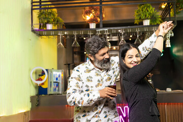 Indian couple dancing at restaurant
