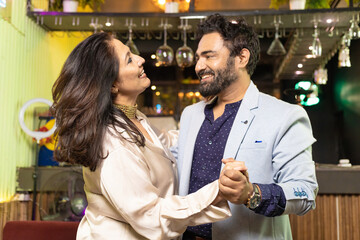 Indian couple dancing at restaurant