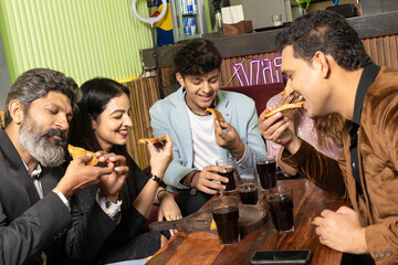 Indian people enjoying food at restaurant