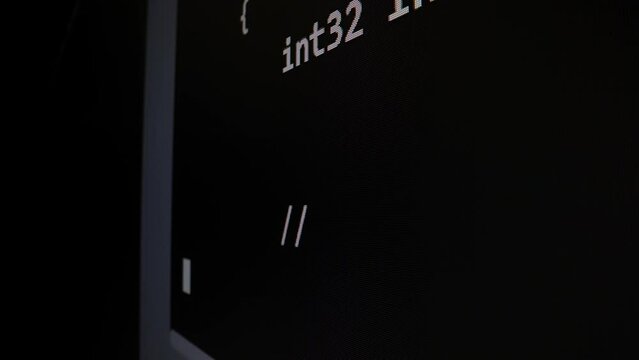 Closeup macro shot movement of coding script moving across LED screen with real-time AI-generated typing, showcasing advanced AI learning in optimization, debug and coding for software development.
