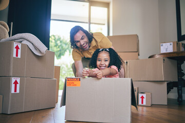 Father, portrait and kid in box of new home for games, fun and freedom in real estate apartment. Excited dad, girl child and interracial family play in cardboard boxes for race while moving to house