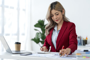 Businesswoman using calculator, laptop to check company finances income and budget Calculate monthly expenses, budget management, documents, loan documents, invoices Finance concept Accounting