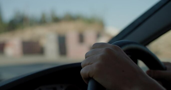 Close-up of female hands on the steering wheel driving a car. A business woman's morning commute to work. High quality 4k footage
