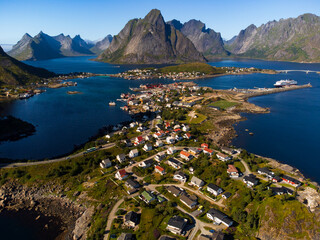 aerial view of Reine in the lofoten islands in norway, deep blue sea, blue sky, tall mountains. - obrazy, fototapety, plakaty