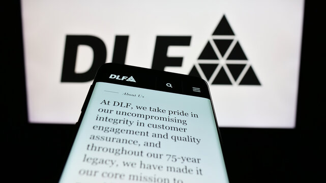 Stuttgart, Germany - 08-06-2023: Mobile phone with webpage of Indian real estate company DLF Limited on screen in front of business logo. Focus on top-left of phone display.