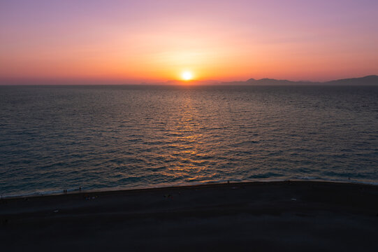 Aerial view of sunset on beach at sea. Rhodes, Greece.