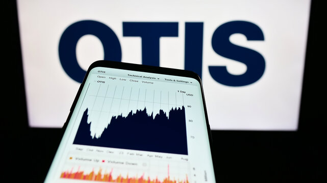Stuttgart, Germany - 08-06-2023: Mobile phone with website of US elevator company Otis Worldwide Corporation on screen in front of logo. Focus on top-left of phone display.