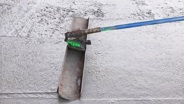 In addition to leveling concrete for driveways, workers use trowel level