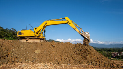 An excavator machine digging soil at a construction project site, showcasing heavy machinery in action, earthmoving work, and industrial development.
