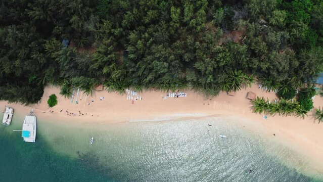 Aerial top view of Hawaii's pristine beach with blue water and white sand