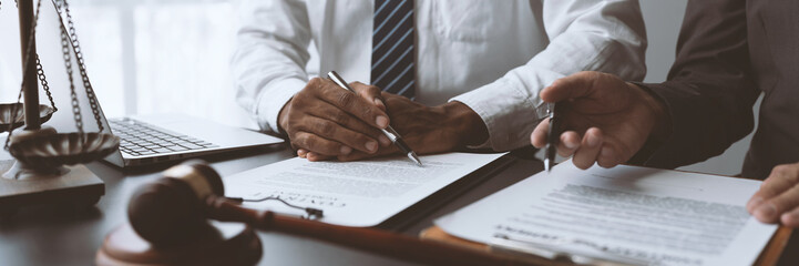 Businessmen or lawyers working together at a meeting, teamwork and partnership. Signing documents,...