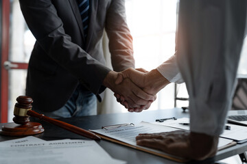 The handshake after a good cooperation, consulting between attorney and client, businessman, tax and real estate project company. - obrazy, fototapety, plakaty