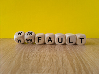 Cubes form words Her fault or His fault. Beautiful yellow background, wooden table. Copy space....