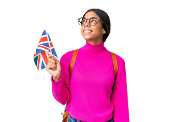 Young African American woman holding an United Kingdom flag over isolated chroma key background thinking an idea while looking up