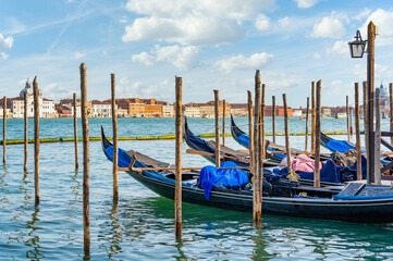 Colorful picture with gondolas moored on Grand Canal near Saint Mark square, in Venice Italy. © Cristi