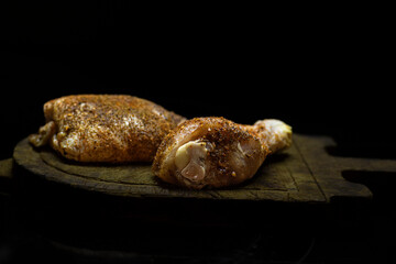 Raw seasoned chicken thigh and leg.