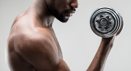 Fototapeta na wymiar Black man lifting weights, determined, strong muscles