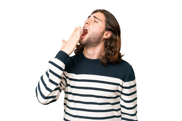 Young handsome man over isolated background yawning and covering wide open mouth with hand