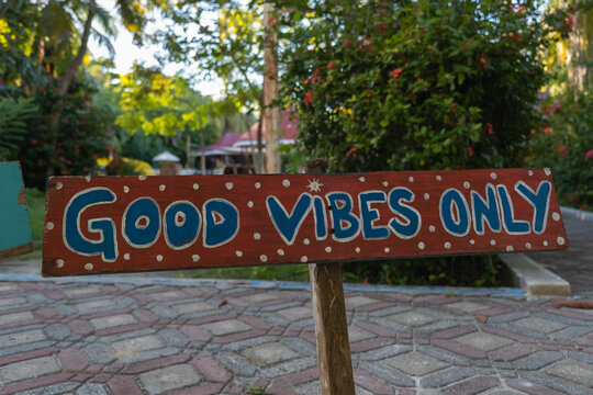 Outdoor sign good vibes only in a tropical resort garden. Positivity, optimism, happiness, kindness, fun, joy, love, hope, peace, acceptance, friendship, harmony, balance, zen concept.