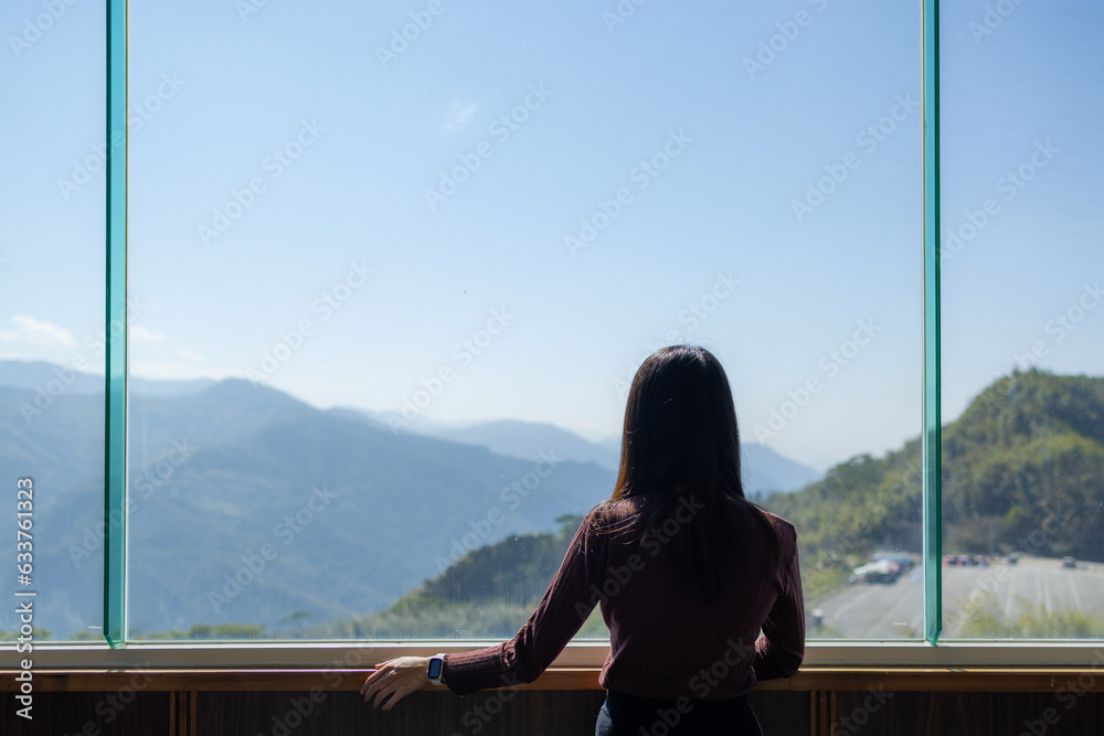 Sticker woman look at the mountain scenery inside the building