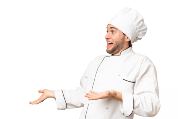 Young handsome chef man over isolated background with surprise facial expression