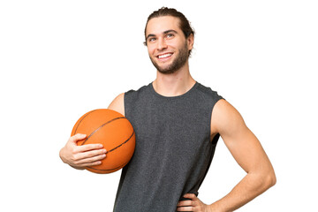 Young basketball player man over isolated background posing with arms at hip and smiling