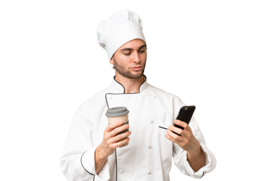 Young handsome chef man over isolated background holding coffee to take away and a mobile