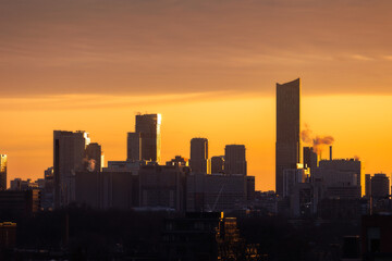 Fototapeta na wymiar Downtown Toronto skyline at sunrise, with golden light illuminating the sky and sides of buildings
