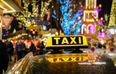 taxi sign in night time lighting behind