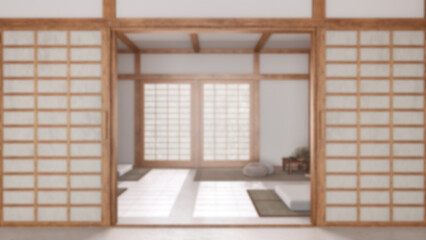 Blurred background, minimal meditation room with paper door. Capet, pillows and tatami mats. Wooden beams and wallpaper. Japandi interior design