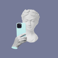 Antique female statue's head holding mobile phone with camera taking a picture or surfing Internet...