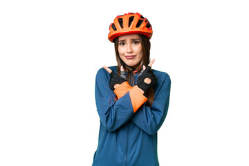 Young cyclist woman over isolated chroma key background pointing to the laterals having doubts