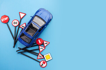 driver education and safety measures through driving schools and academies, car and road signs on a blue background, copy space