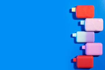 disposable vapes, ecigarette, different electronic cigarettes on a blue background, copy space