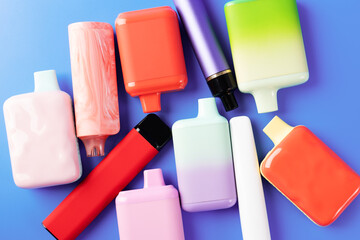 disposable liquid vaporizers on a blue background, vapes