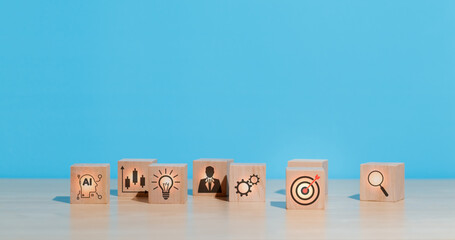 wooden cube with dart board target icon on table , concept of target and goals achieved, creativity...