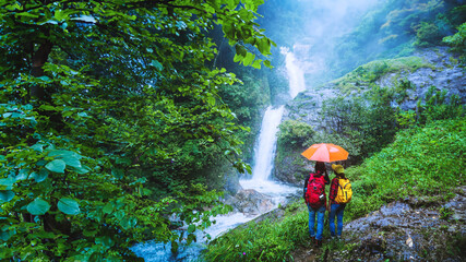 Lover asian man and asian women travel nature Travel the highest waterfall in Chiangmai Mae-pan...