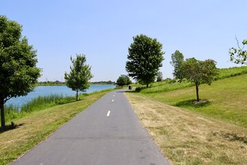 The empty pathway in the park on a sunny day.