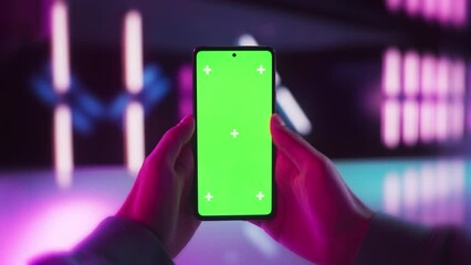 Video Gamer Checking a Social Network Post on Smartphone with Mock Up Green Screen Chromakey Display. Scrolling, Swiping, Tapping on the Mobile Phone. Concept for Online Services Presentation - Powered by Adobe