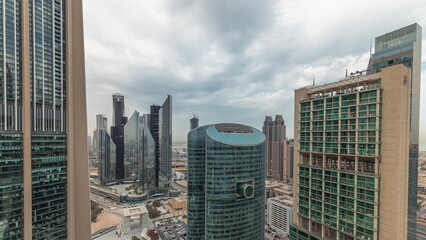 Fototapeta na wymiar Panorama showing Dubai international financial center skyscrapers with promenade on a gate avenue aerial timelapse.