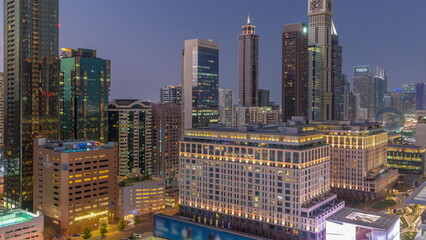 Naklejka premium Dubai International Financial district aerial day to night timelapse. Panoramic view of business and financial office towers.