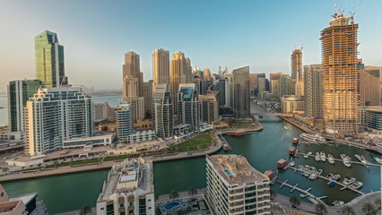 Panorama showing Dubai Marina skyscrapers and JBR district with luxury buildings and resorts aerial timelapse