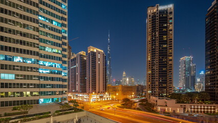 Aerial panoramic view to Dubai downtown and difc skyscrapers day to night timelapse.