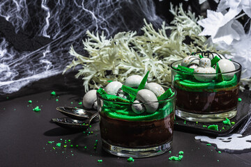 Halloween dessert with traditional decor. Sweet mushrooms, ghost, spider and bat