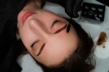 Beautiful model girl with permanent make-up of eyebrows. Eyebrow permanent makeup cosmetic procedure.