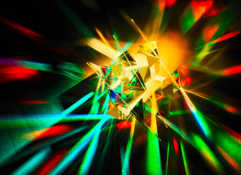 Top view of mixture various sizes of glass triangular prism and dichroic translucent stripe scattering strong beam of light into several colour spectrums with different directions of colourful shadows - Powered by Adobe
