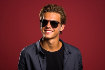 Fototapeta premium Portrait of a fictional handsome man with sunglasses smiling. Isolated on a plain background. Generative AI.
