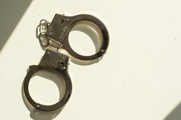 Handcuffs Short Chain Black Metal on white. 3D illustration