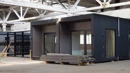 Exhibition of new and modern prefabricated modular house from composite wood panels. Energy efficient panel assembling
